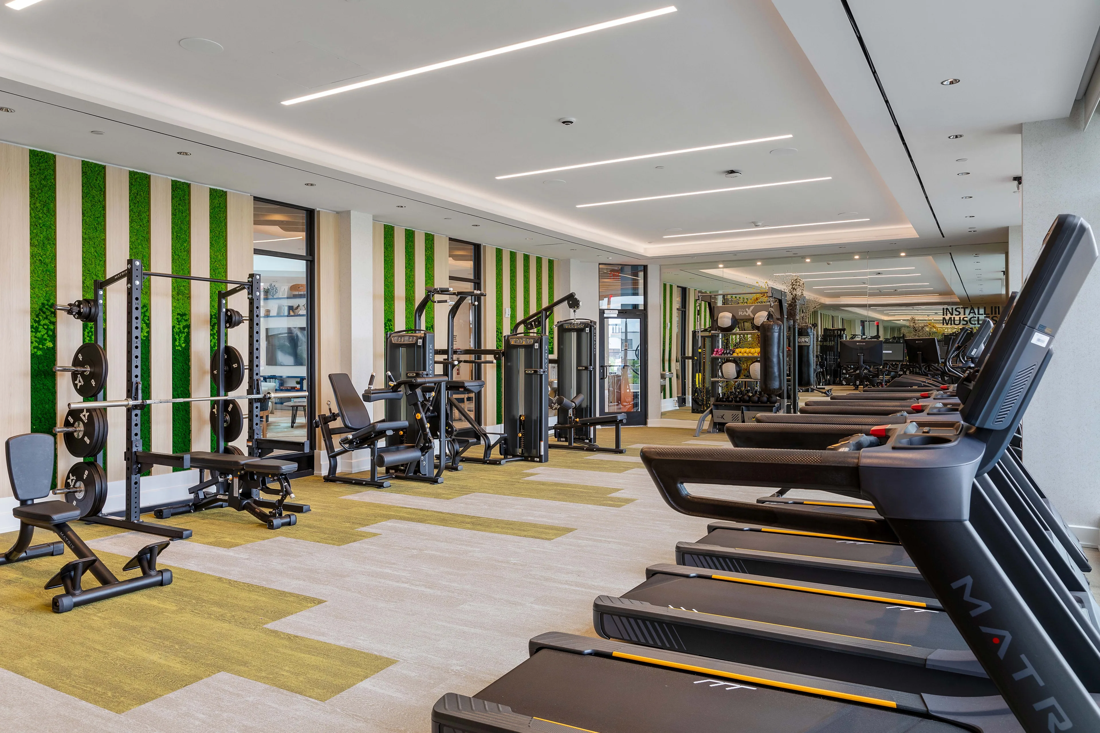 Modern apartment fitness center with cardio and strength equipment