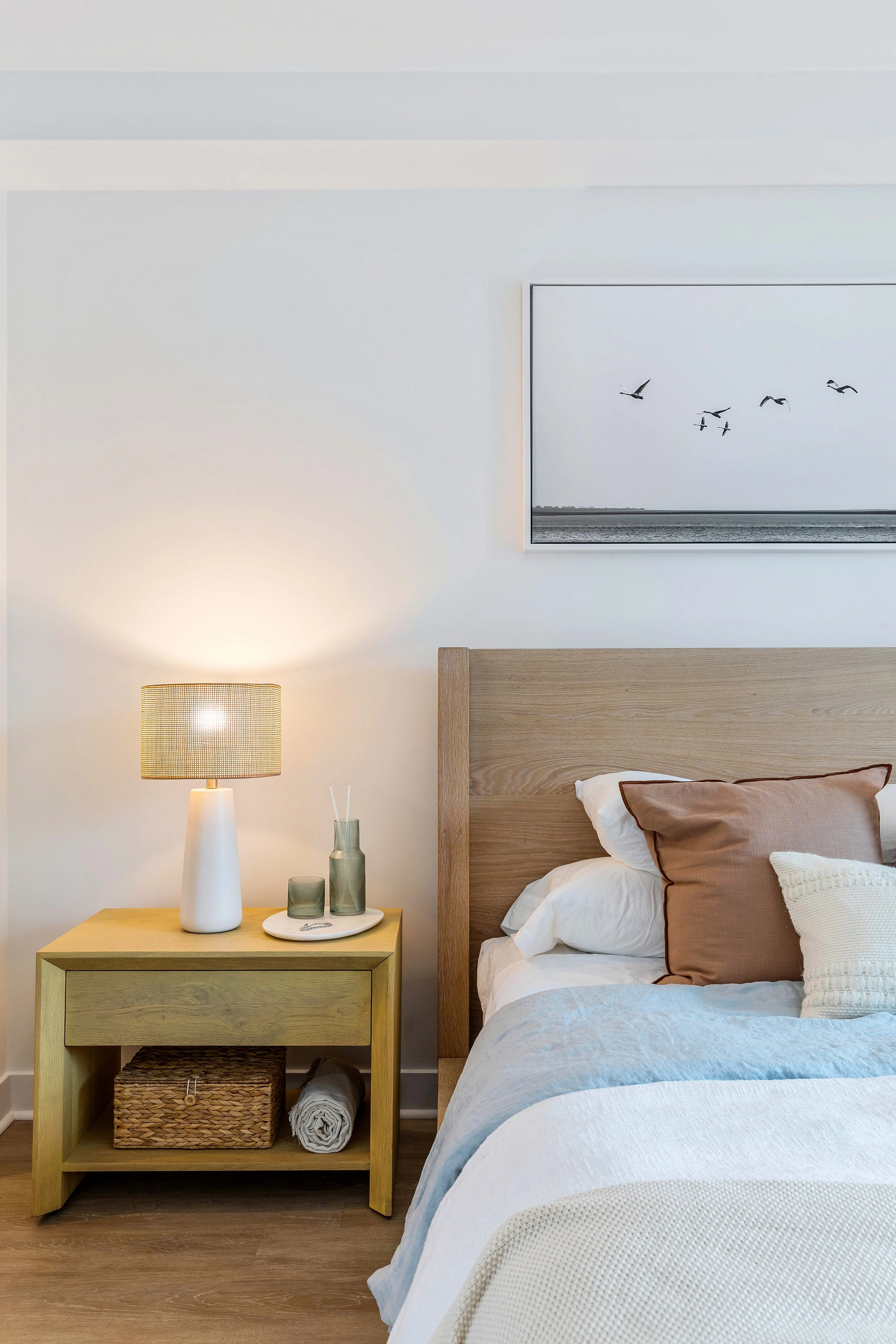 Modern bedroom with natural wood furnishings and coastal decor
