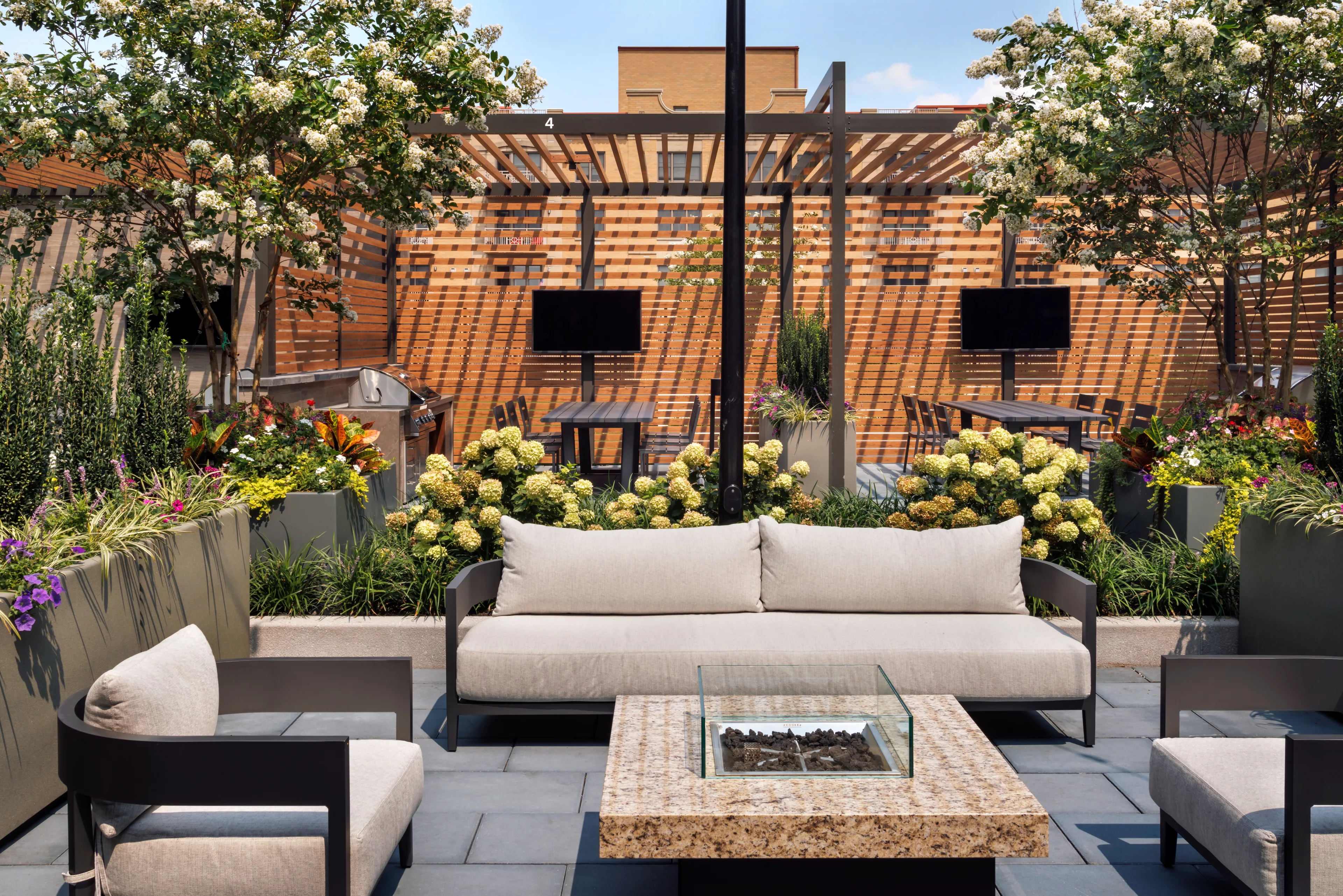 Outdoor resident lounge with fire pit and landscaped patio