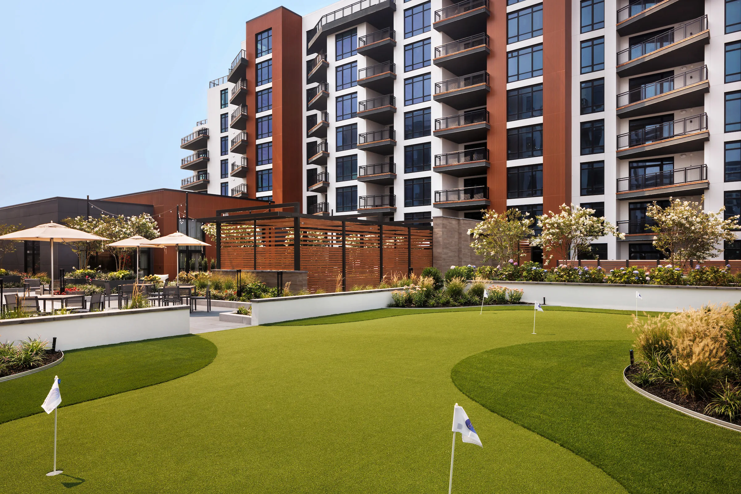 Luxury apartment courtyard with putting green and outdoor seating