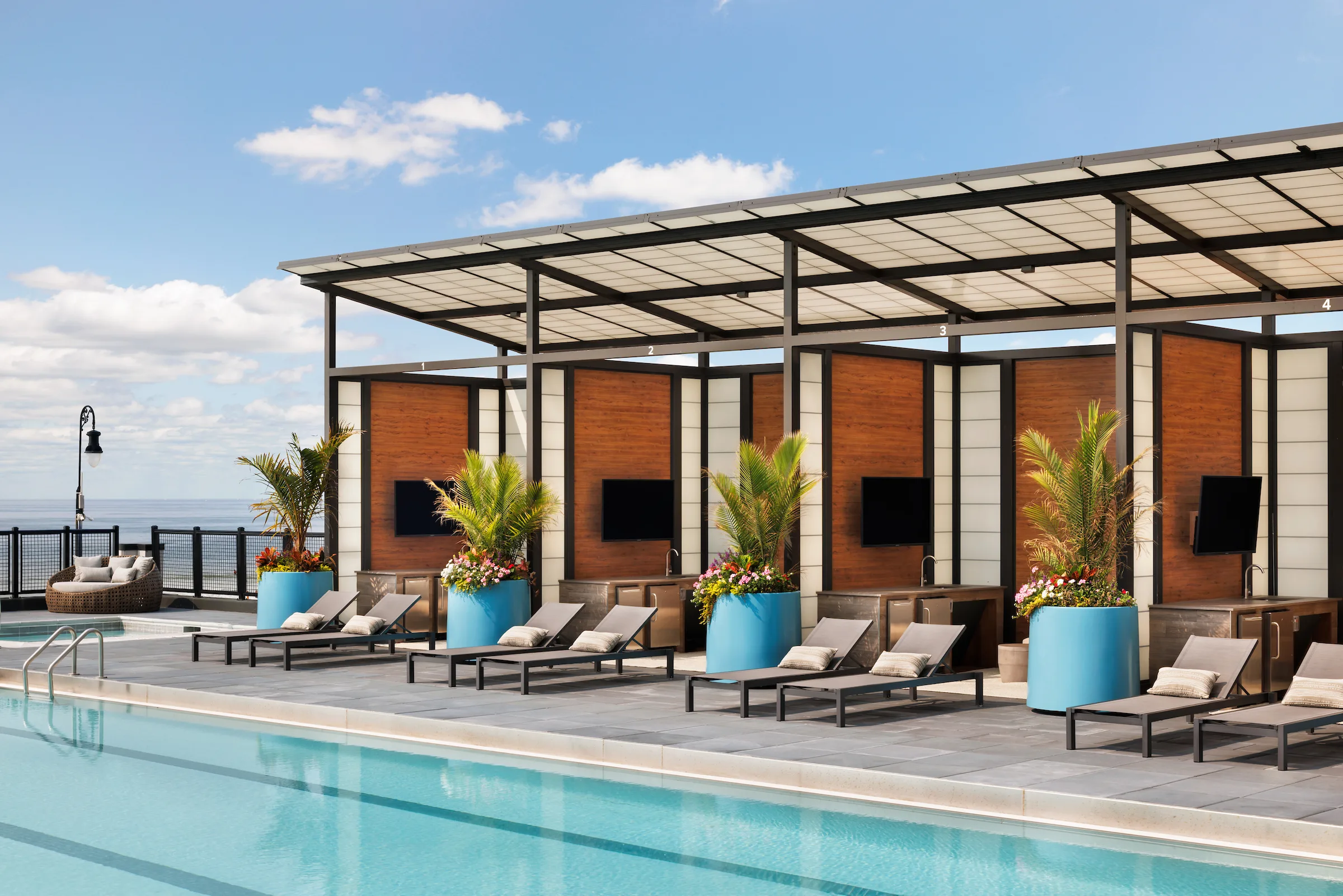 Luxury outdoor pool with cabanas and lounge seating