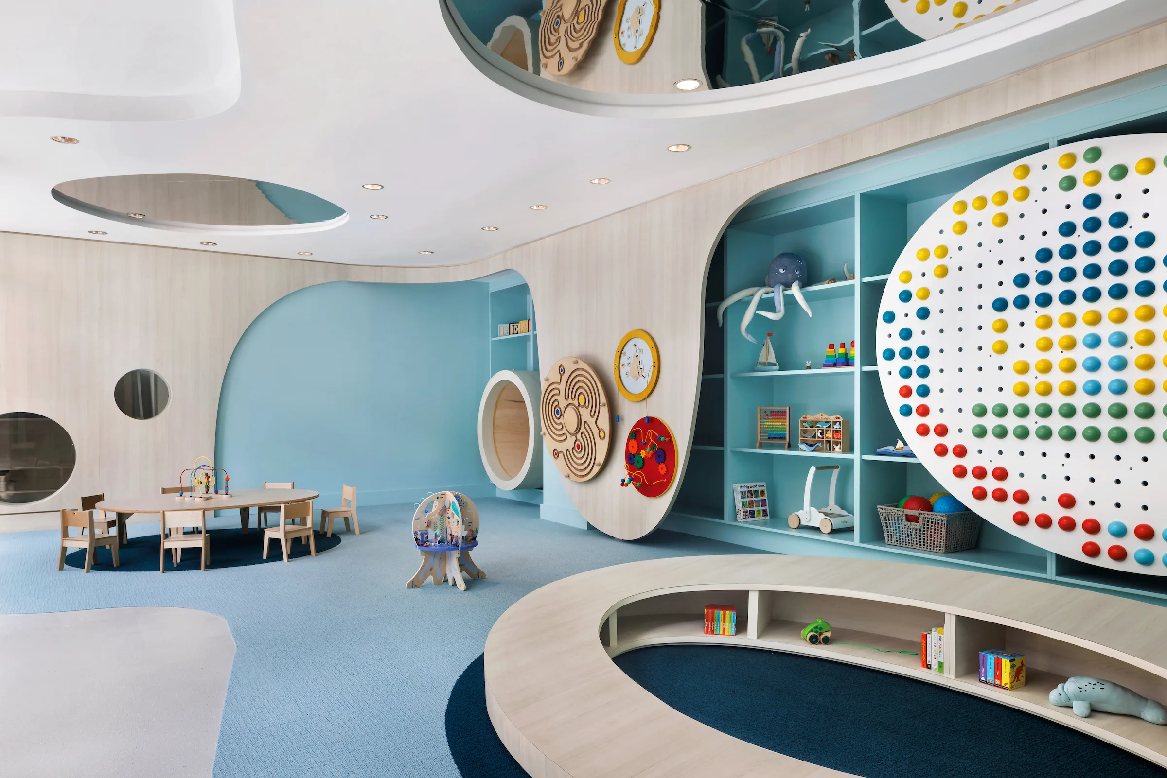 Modern children’s playroom with interactive wall and activity areas