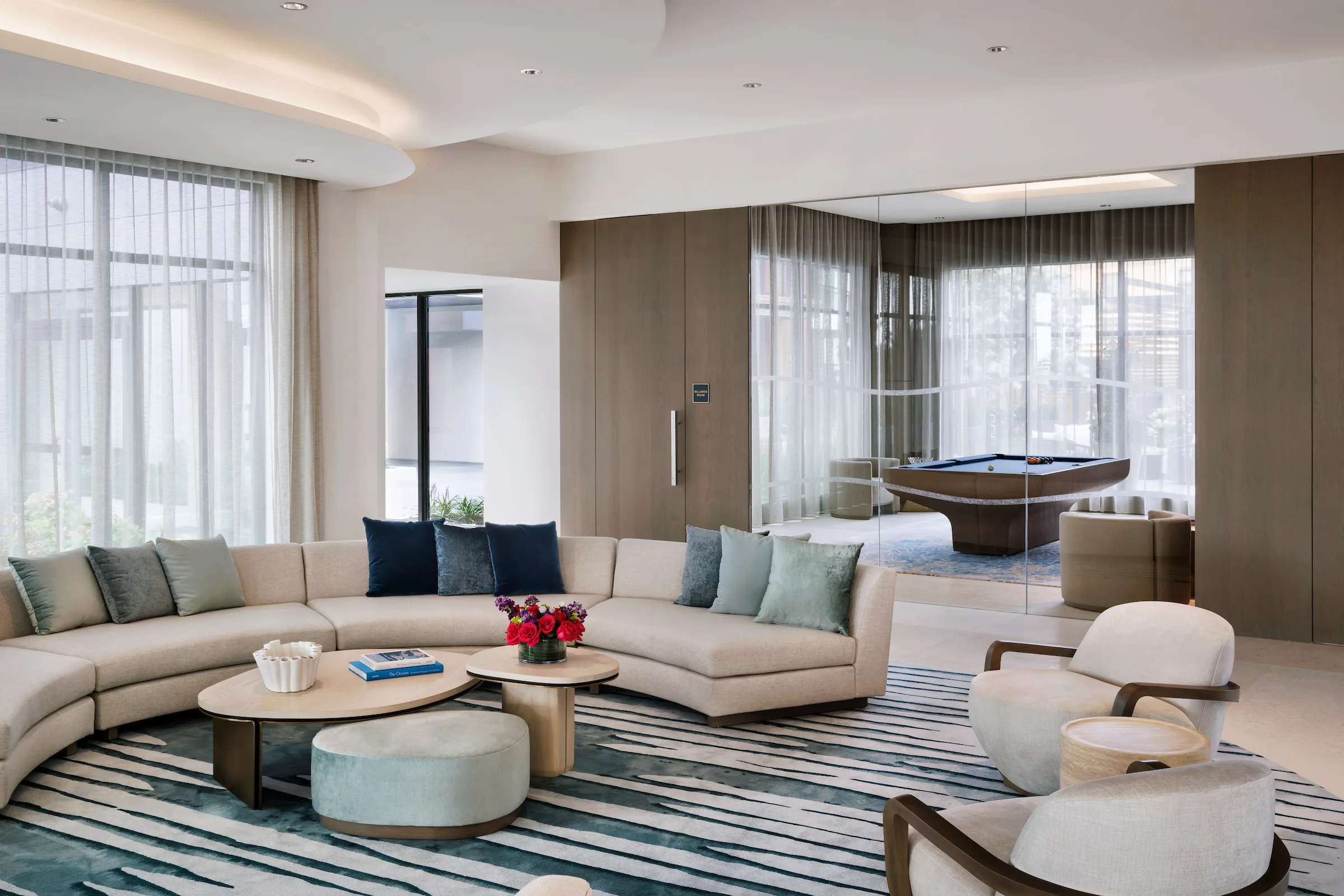 Contemporary resident lounge with sectional seating and billiards room