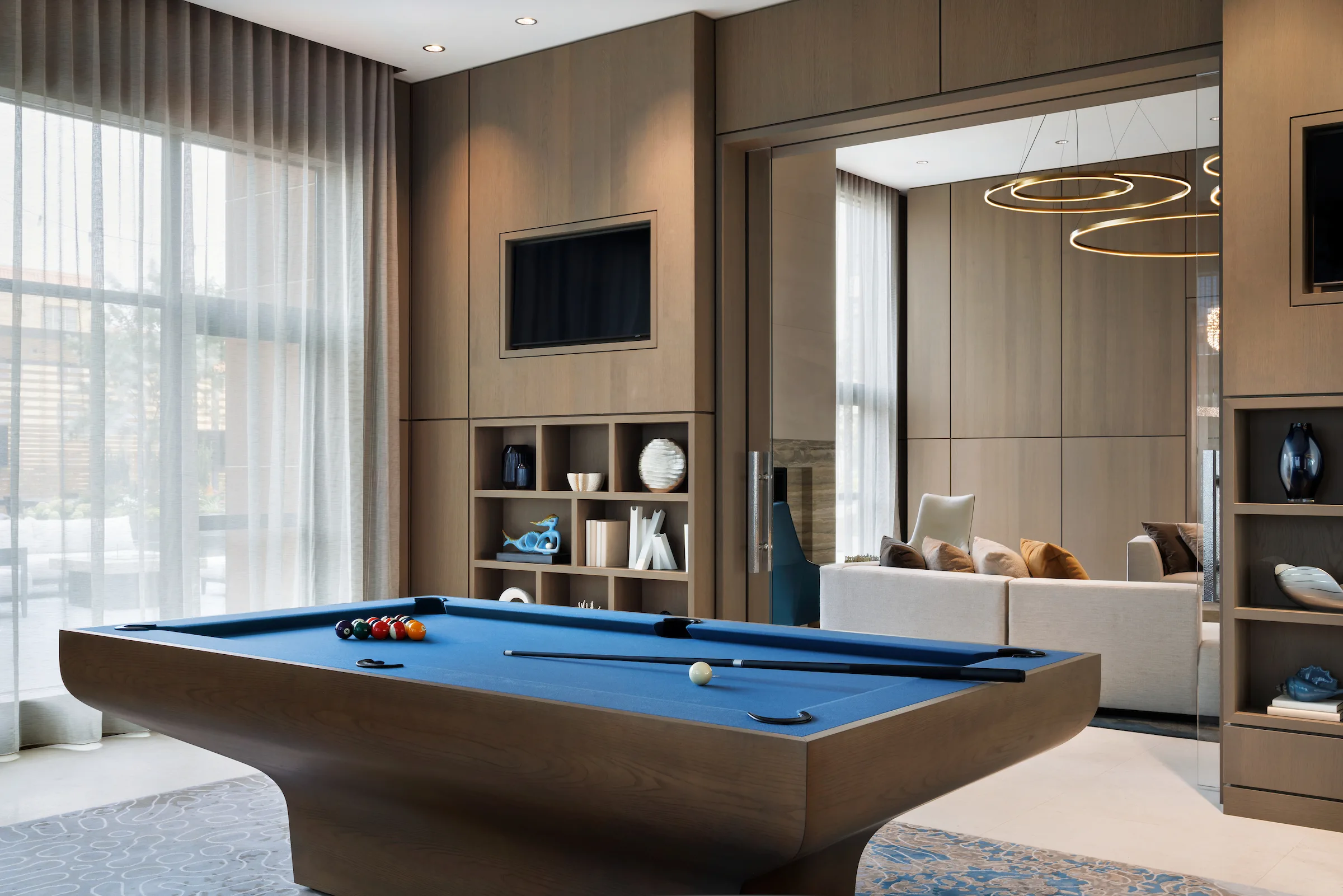 Modern billiards room with custom pool table and built-in cabinetry