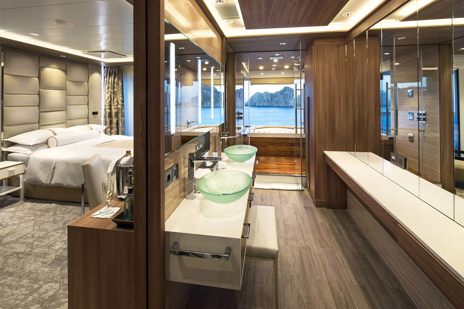 Luxury cruise ship spa suite with bedroom, double vanity and ocean-view bathroom