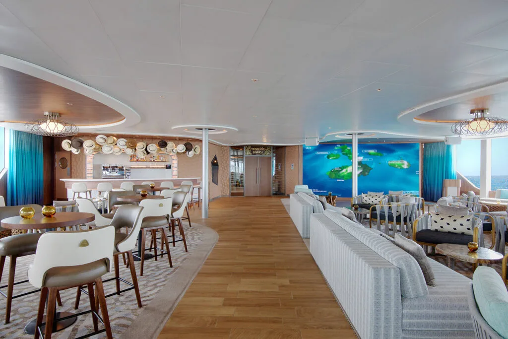 Flora lounge with bar, sofas, and ocean views.