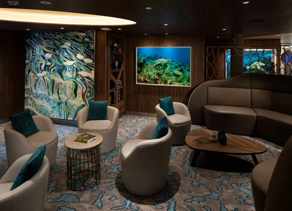 Intimate lounge with marine artwork and blue accents.