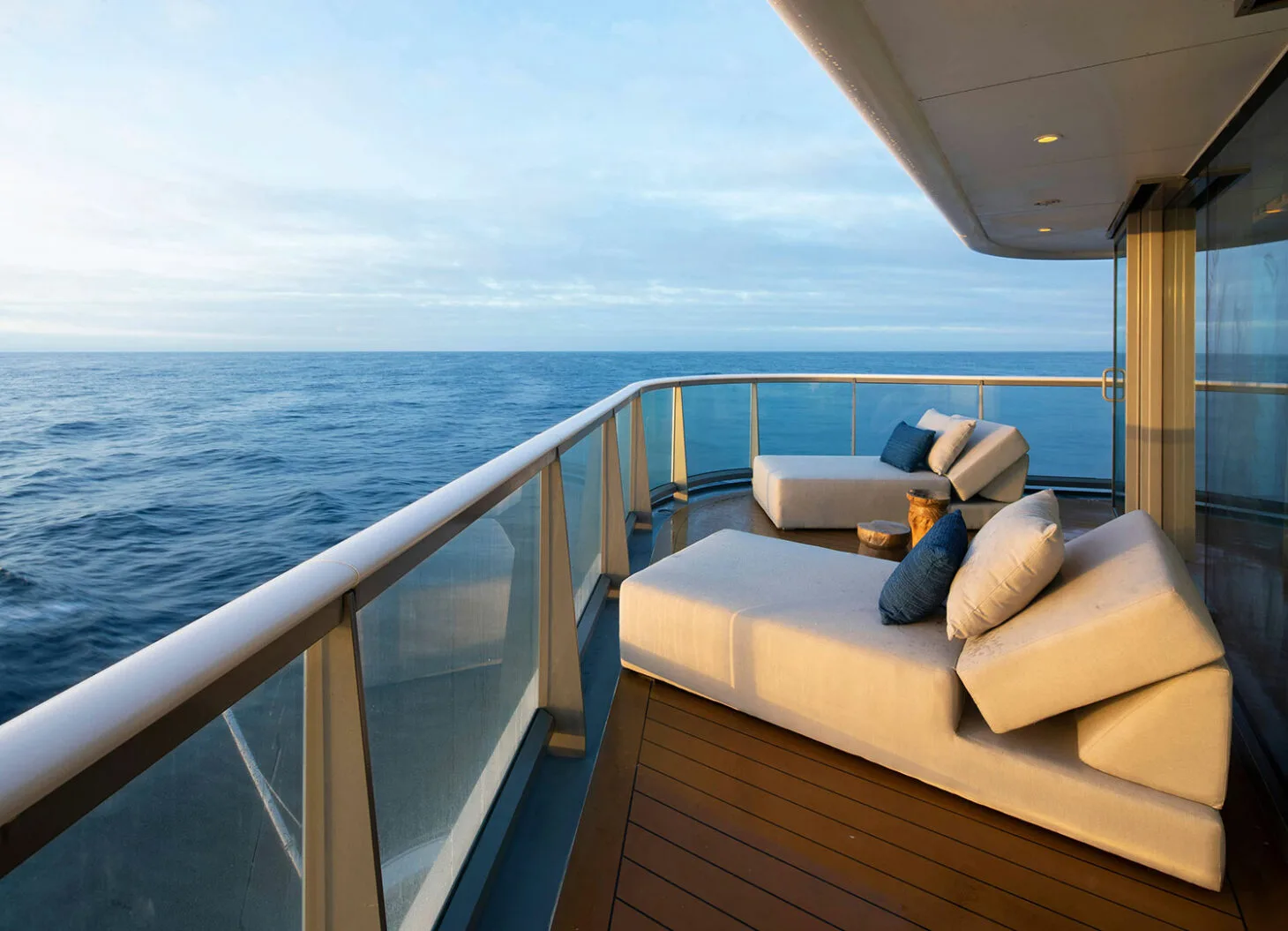 Private balcony with daybeds overlooking the ocean.