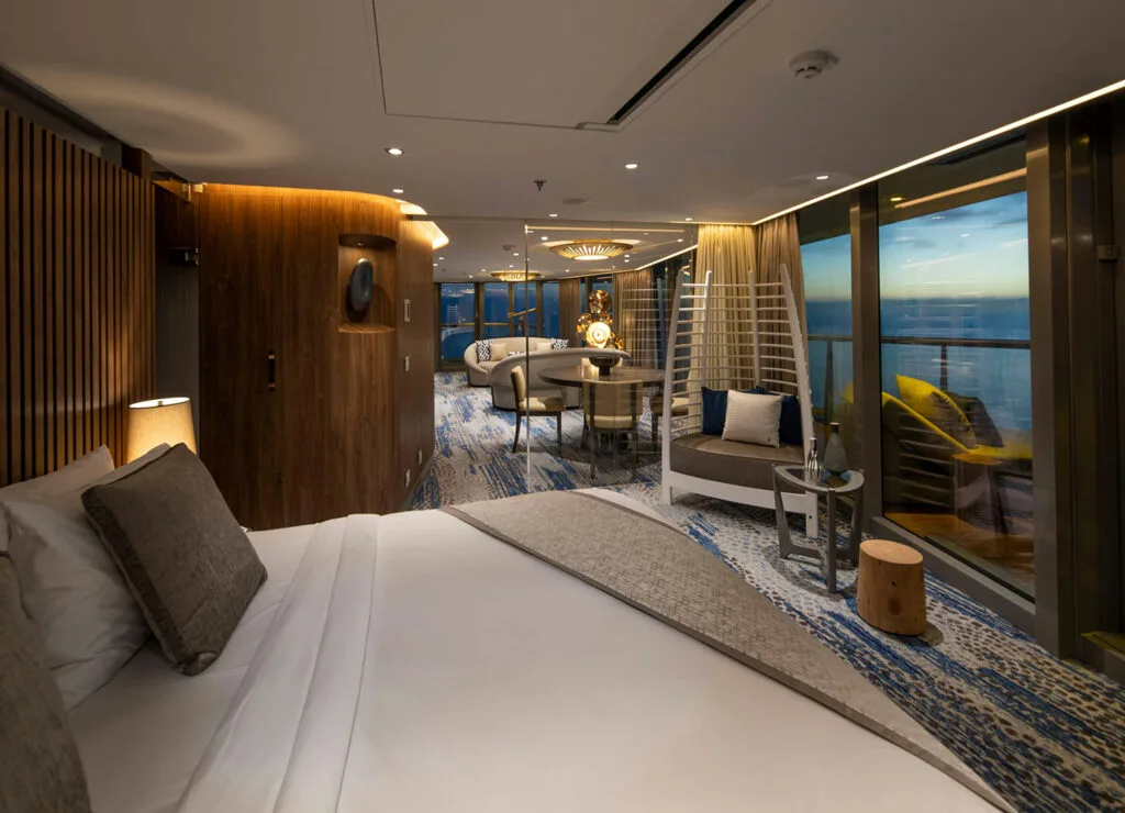 Spacious suite bedroom opening onto a balcony.