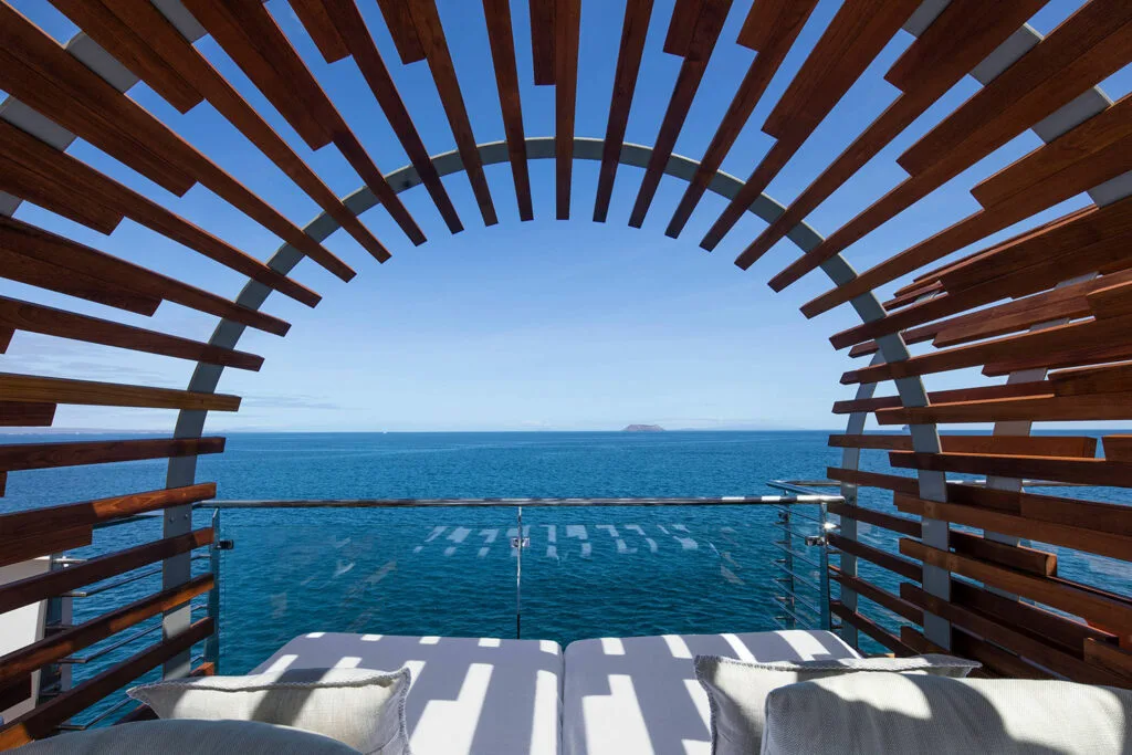 Wood-framed daybeds overlooking the ocean.