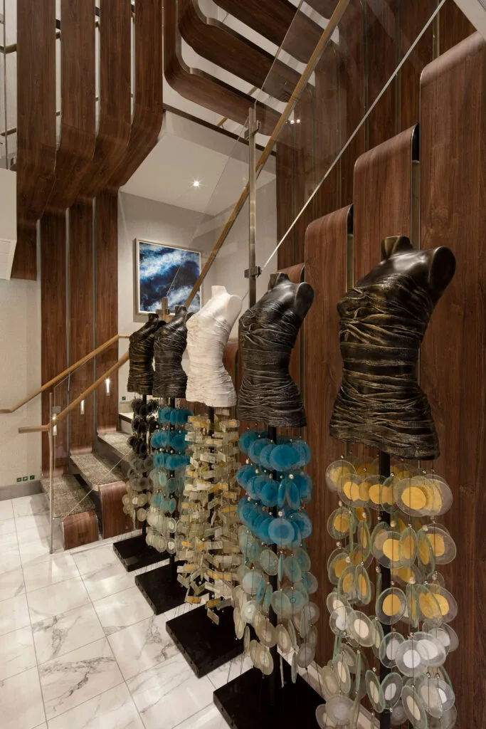 Sculptural display beside a wood-paneled stairway.