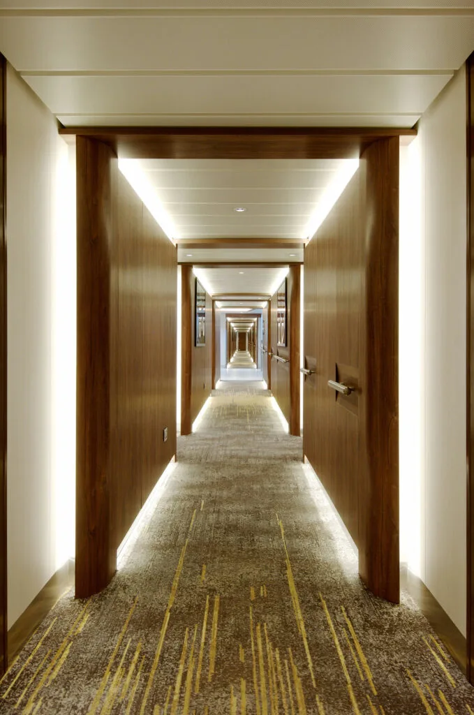 Wood-paneled guest corridor aboard Flora.