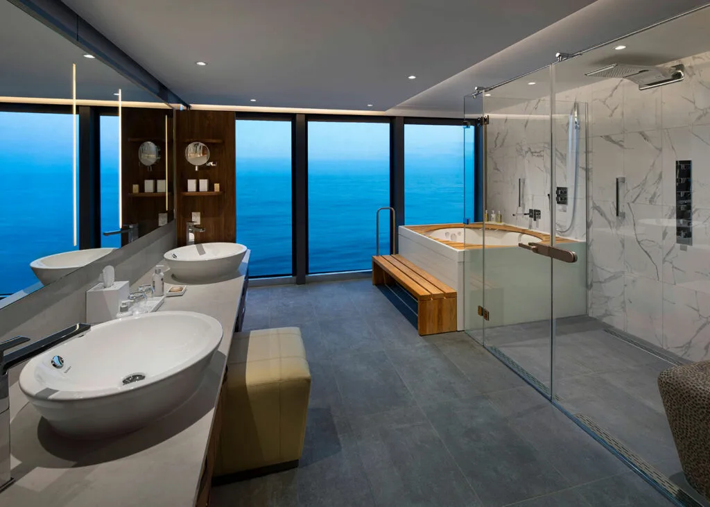 Marble suite bathroom with ocean-view spa tub.
