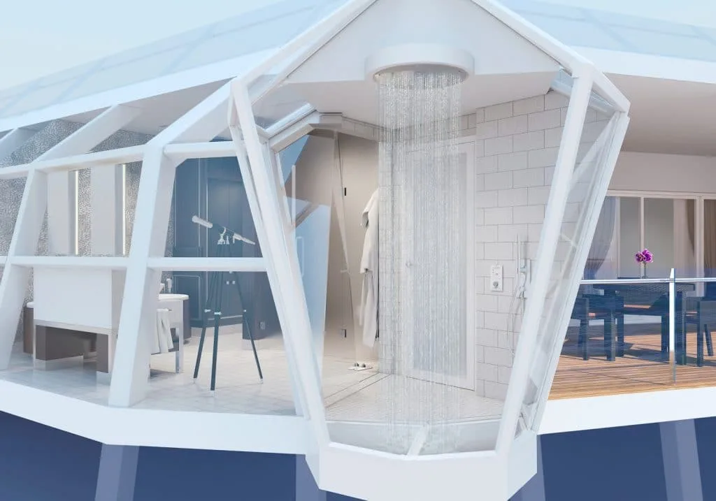 Modern glass-enclosed rainfall shower in a luxury hospitality suite.
