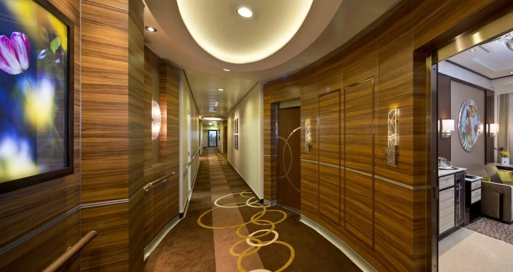 Luxury hotel corridor with wood-paneled walls, modern lighting and suite entrance