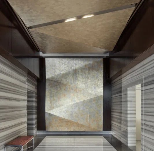 Modern lobby hallway with marble finishes and decorative feature wall