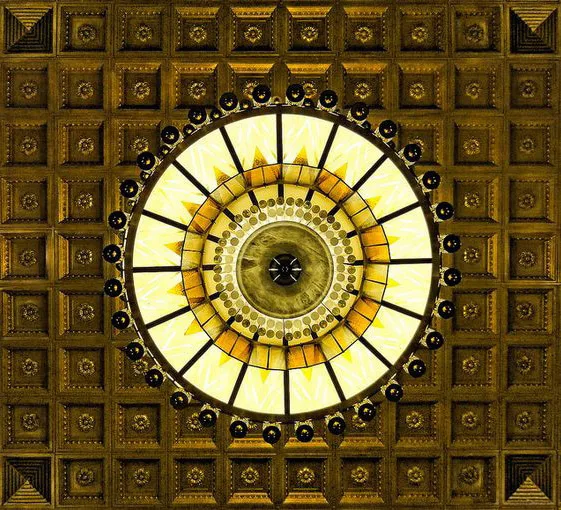 Ornate Art Deco ceiling and circular light fixture at The New Yorker Hotel.